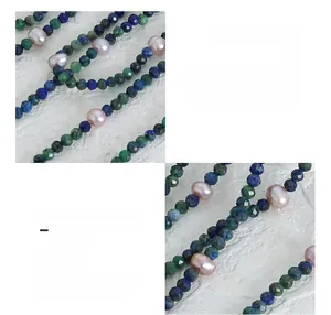 Macro detail of natural lapis lazuli and freshwater pearls on 18K gold plated titanium chain