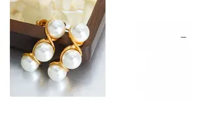 Detailed shot of French vintage gold wire wrapped pearl earrings with a sleek finish