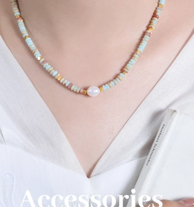 Detail of bohemian beaded necklace with natural blue stones and a baroque pearl