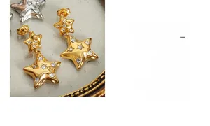 Detailed macro view of 18k gold plated star earrings with sparkling pavé crystals