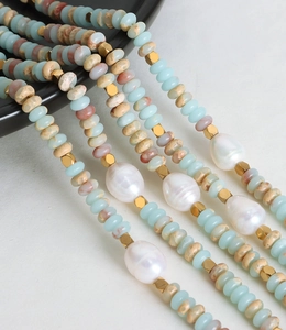Close-up of Baroque pearls with blue and gold beads on a Bohemian style necklace