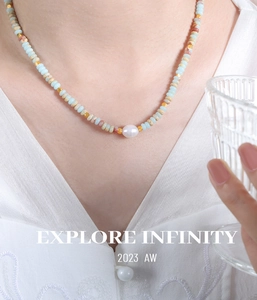 Detail of colorful stone beads and freshwater pearl necklace on model neck