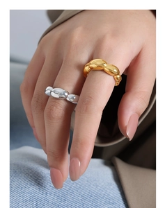 Detail of minimalist 18k gold and silver irregular liquid metal open rings on fingers
