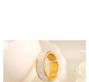 Macro shot of minimalist gold wave ring with white enamel finish and inner brushed texture