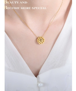Macro detail of 18k gold plated stainless steel necklace with Chinese Fu character pendant