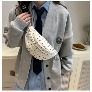 Polka dot canvas chest bag with adjustable strap and colorful pattern on white background