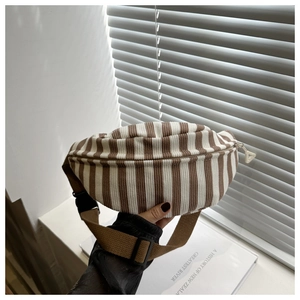 Close-up of retro striped corduroy waist bag with adjustable strap and zipper closure