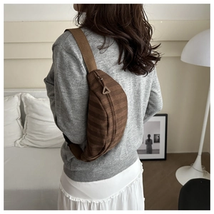 Detail view of the brown corduroy moon bag with adjustable shoulder strap and zipper