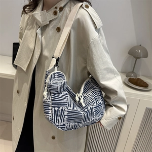 Minimalist striped knit shoulder bag in navy and white with matching round coin purse