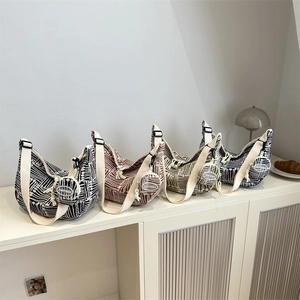 Striped canvas hobo bags with circular coin pouches in black, brown, green and blue colors