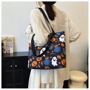 Detail of canvas tote bag with Halloween ghost and pumpkin print on black fabric