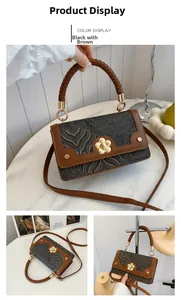 Detailed view of black and brown crossbody bag with wave pattern and golden flower clasp