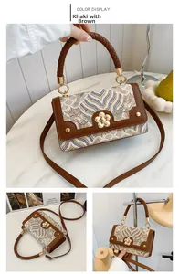 Detail of khakibrown crossbody bag with wave embroidery and gold flower metal lock