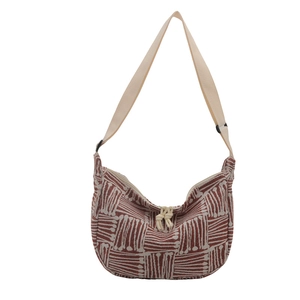 Striped crescent tote bag with red and white geometric patterns and woven knot detail