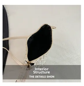 Internal structure of the tweed crescent bag showing black lining and gold zipper