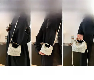 Three-way tweed handbag showing shoulder, crossbody, and hand-carry styles with gold hardware