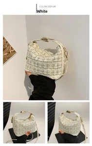 Detail of tweed texture and gold hardware on white plaid crossbody small square bag