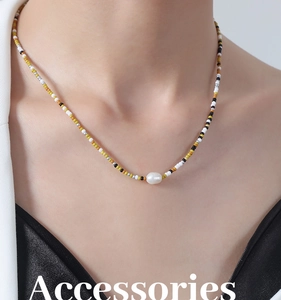 Detail of beaded pearl necklace with colorful glass seed beads on a female model neck
