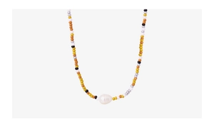 Close-up of colorful glass beads and a large white pearl pendant on the necklace