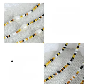 Macro detail of mixed glass beads and freshwater pearl necklace with 18K gold plating