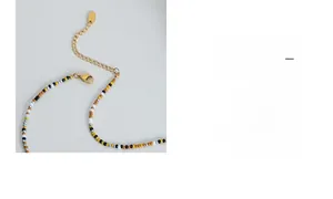 Detail of beaded necklace with multicolor glass beads and golden lobster clasp