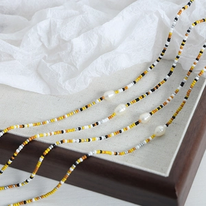 Multilayer handmade seed bead necklace with irregular pearls in vibrant summer colors