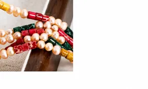 Detail of pink pearls and colorful rectangular stone beads on a vintage necklace