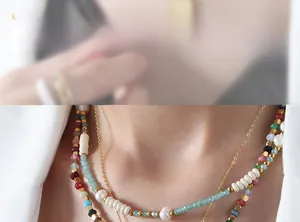 Detail of layered beaded necklace with colorful jasper stones and freshwater pearls