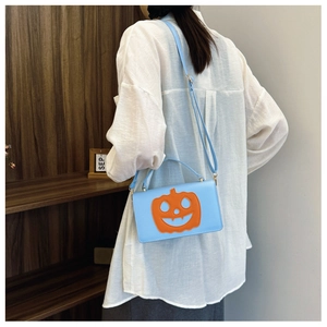 Detail of light blue PU leather bag with pumpkin patch and adjustable shoulder strap