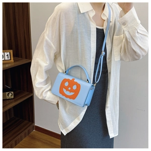 Blue leather pumpkin square bag with orange smiley face patch and adjustable strap