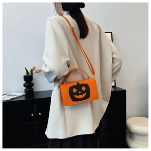 Fashionable PU leather pumpkin crossbody bag with festive smiling face on white blazer