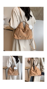Detail of khaki crinkled nylon tote bag featuring silver butterfly charms and cloud pendant
