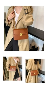 Detailed views of a brown retro crossbody bag with a gold metal buckle on a beige coat