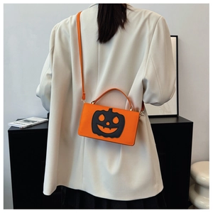 Chic orange pumpkin crossbody bag styled with a white blazer for Halloween vibes