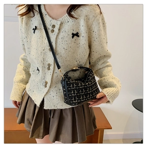 Detail view of mini tweed crossbody bag with gold hardware and stylish chain strap