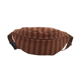 Brown striped corduroy fanny pack with adjustable strap and metallic zipper closure