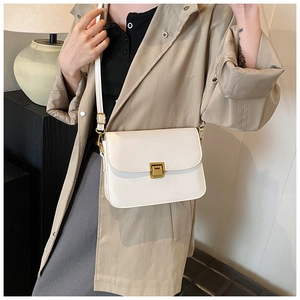 Close-up of a white rectangular crossbody bag with a gold metal lock on a model