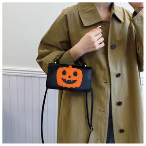 Halloween small crossbody bag with orange pumpkin face on black faux leather material