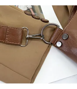 Detail of a brown lychee pattern leather strap with gunmetal swivel snap hook