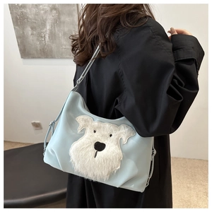 Detail of light blue nylon tote bag featuring cute white plush dog patch decoration