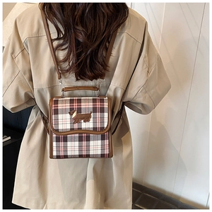 Detailed back view of a plaid square crossbody bag with cute dachshund patch