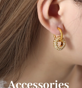 Close-up of gold-plated hoop earrings with micro-pave crystal zircons on female model
