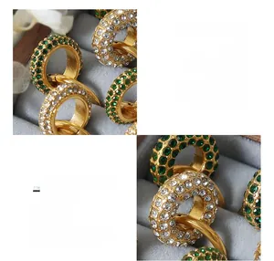 Macro detail of 18K gold plated titanium earrings featuring inlaid Czech diamonds
