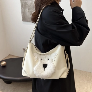 Chic beige tote bag with a white plush puppy design and minimalist shoulder strap