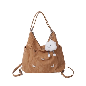 Caramel nylon tote bag with silver butterfly charms and plush cloud pendant