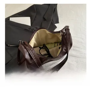 Interior view of large capacity dark brown leather tote bag with plush detail and essentials