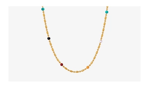 Detail view of gold titanium steel necklace with colorful beads and bamboo links