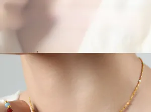 Detail shot of chic gold chain necklace with colorful bead accents on female model
