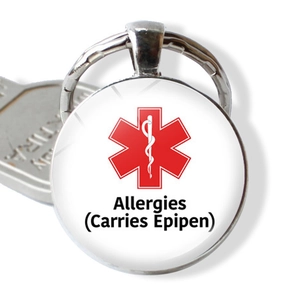 Detail of medical alert keychain with red star of life and allergies warning text