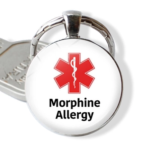 Macro detail of medical alert keychain with Morphine Allergy text and red Star of Life